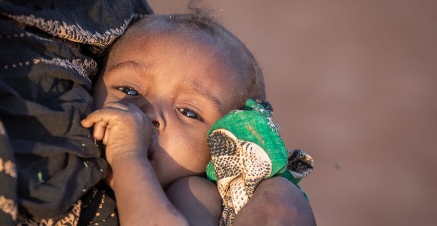 The Season of Giving - #GivingTuesday Young child suffering from food insecurity is comforted in its mother's arms in the Somali region of Ethiopia in March 2023.